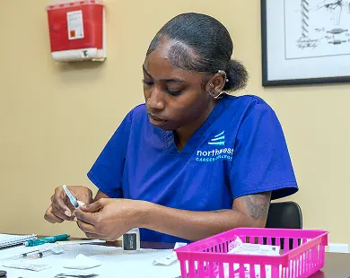 Medical Assistant training program student in Las Vegas preparing medical supplies during class at Northwest Career College