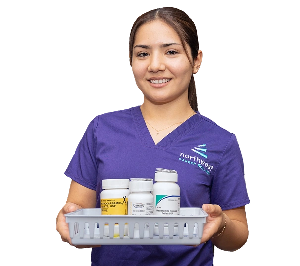 Pharmacy Technician student in Las Vegas at Northwest Career College holding tray of medicine bottles