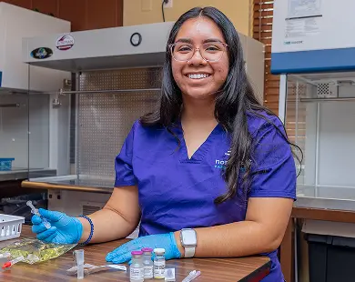 Pharmacy Technician training student in Las Vegas at Northwest Career College practicing medication preparation in lab